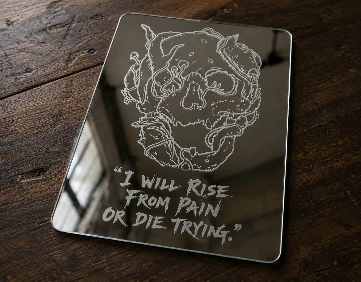 Calavera con frase I will rise from pain — grabado en espejo